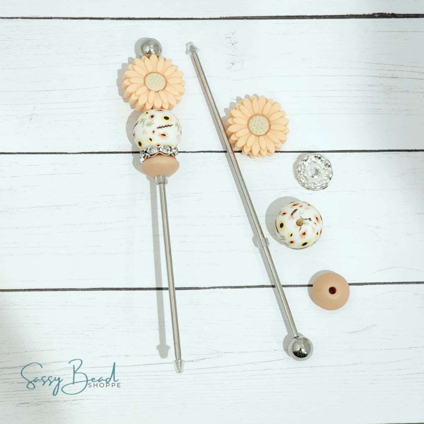 Close-up of flower-themed silicone beads in floral designs for DIY cookie scribe making