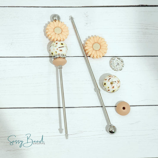 Close-up of flower-themed silicone beads in floral designs for DIY cookie scribe making