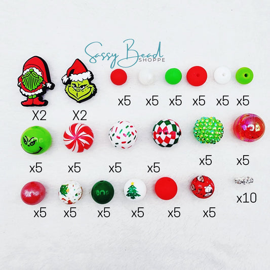 Close-up of Jolly Good Guy bead craft kit styled flat lay showing how many beads you will receive. You will also receive 2 beadable pens & 1 Tumbler cup charm. This unique bead mix includes seasonal Christmas designs
