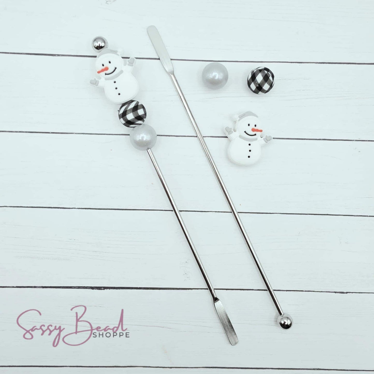 Close-up of Snowman-themed silicone beads in Winter designs for DIY stir stick making