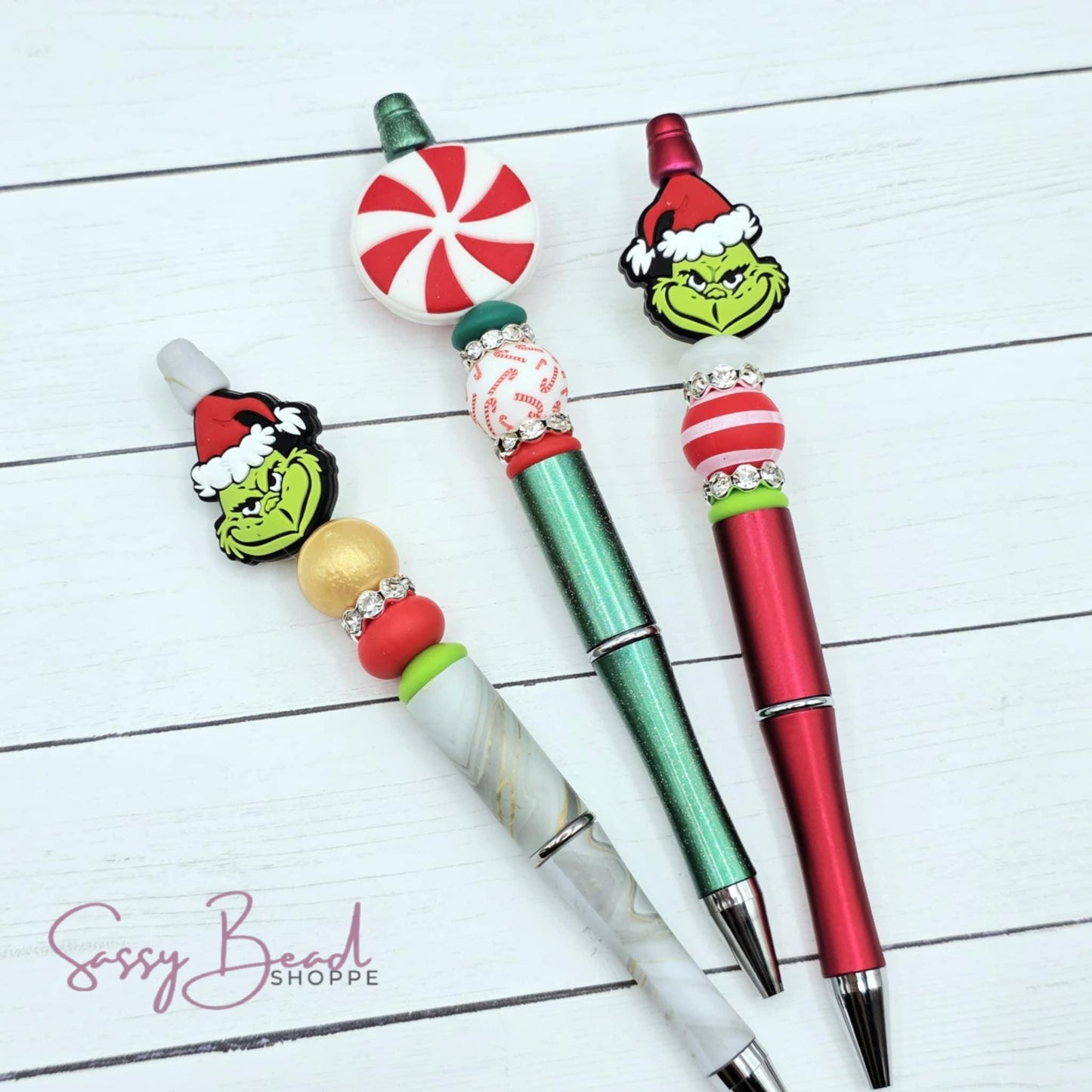 Holiday Mischief beadable pen kit with 3 silicone focal beads — 2 green guy, and pepperment — plus accent beads