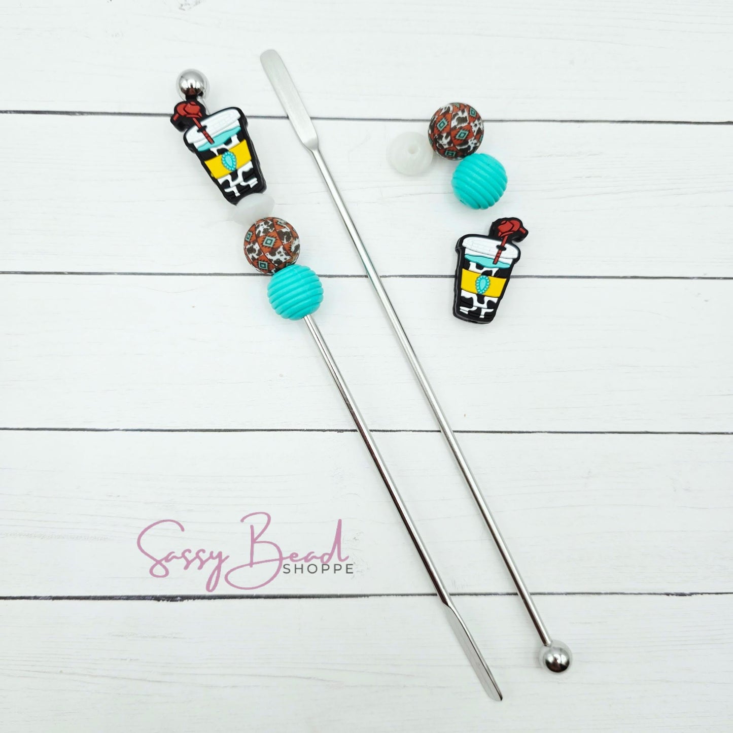 Close-up of western-themed silicone beads in ice coffee tumber& western designs for DIY stir stick making