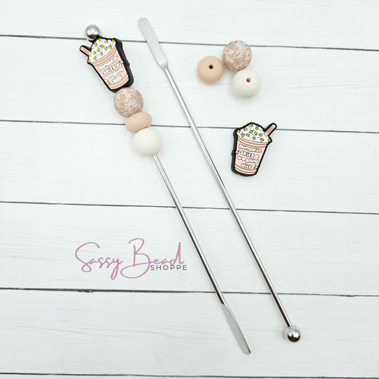 Close-up of Ice Coffee-themed silicone beads in Pumpkin Spice designs for DIY stir stick making