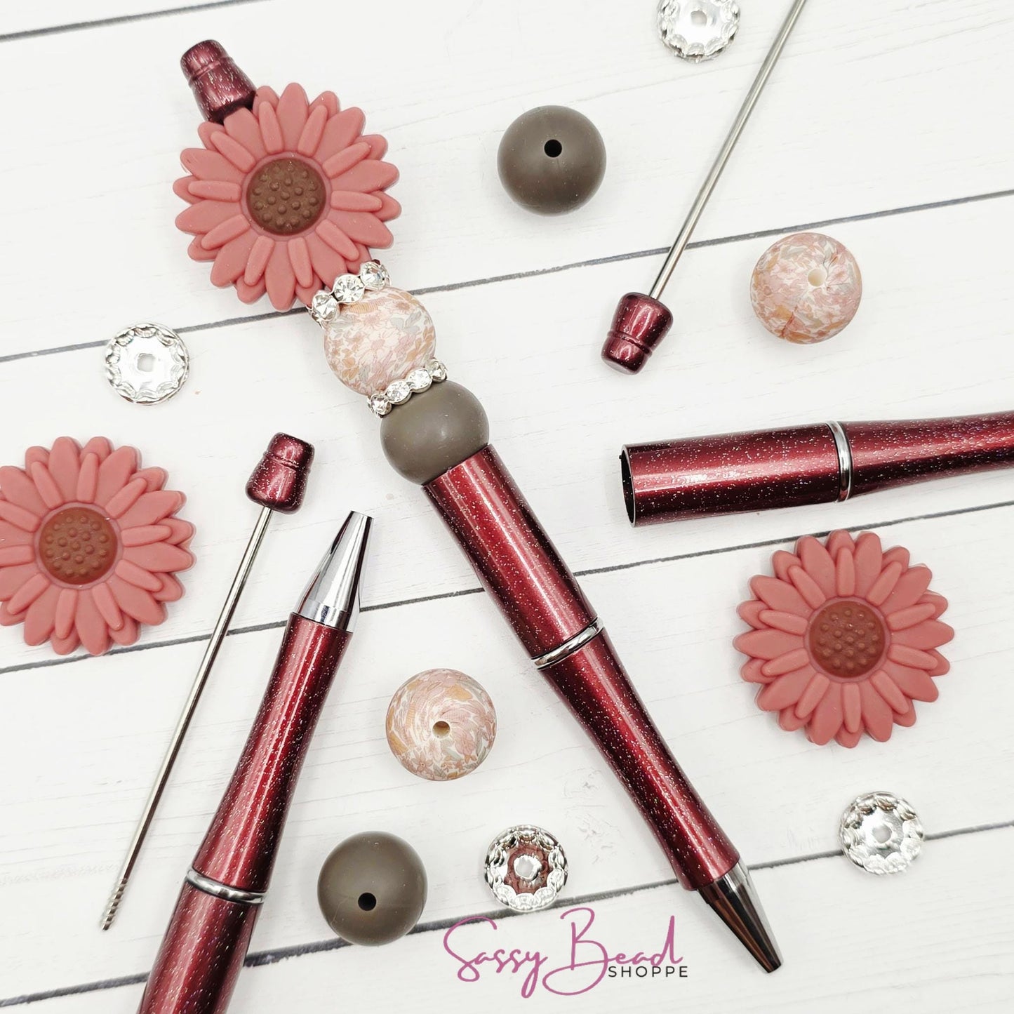 Close-up of flower-themed silicone beads in floral designs for DIY pen making