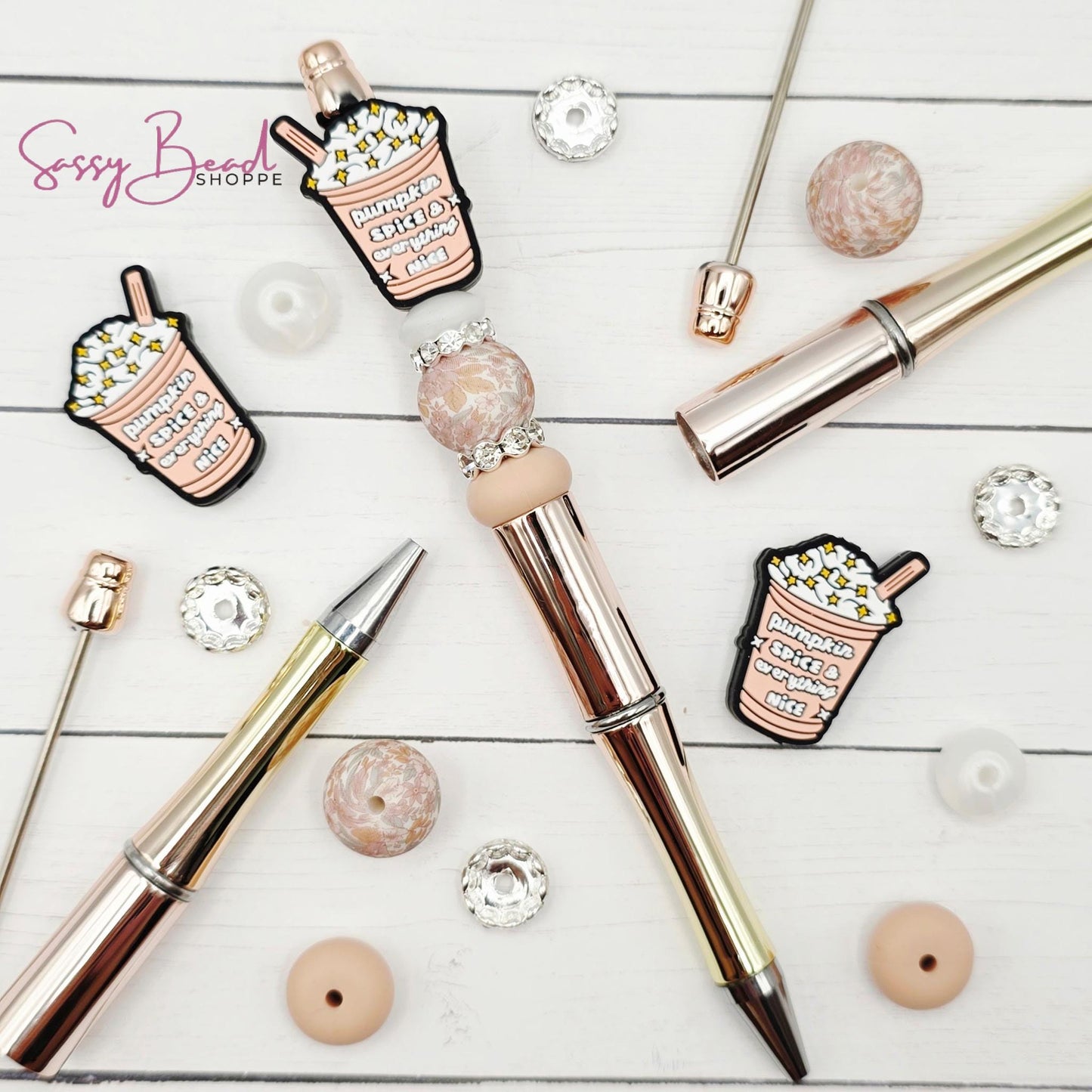 Close-up of pumpkin spice-themed silicone beads in ice coffee designs for DIY pen making