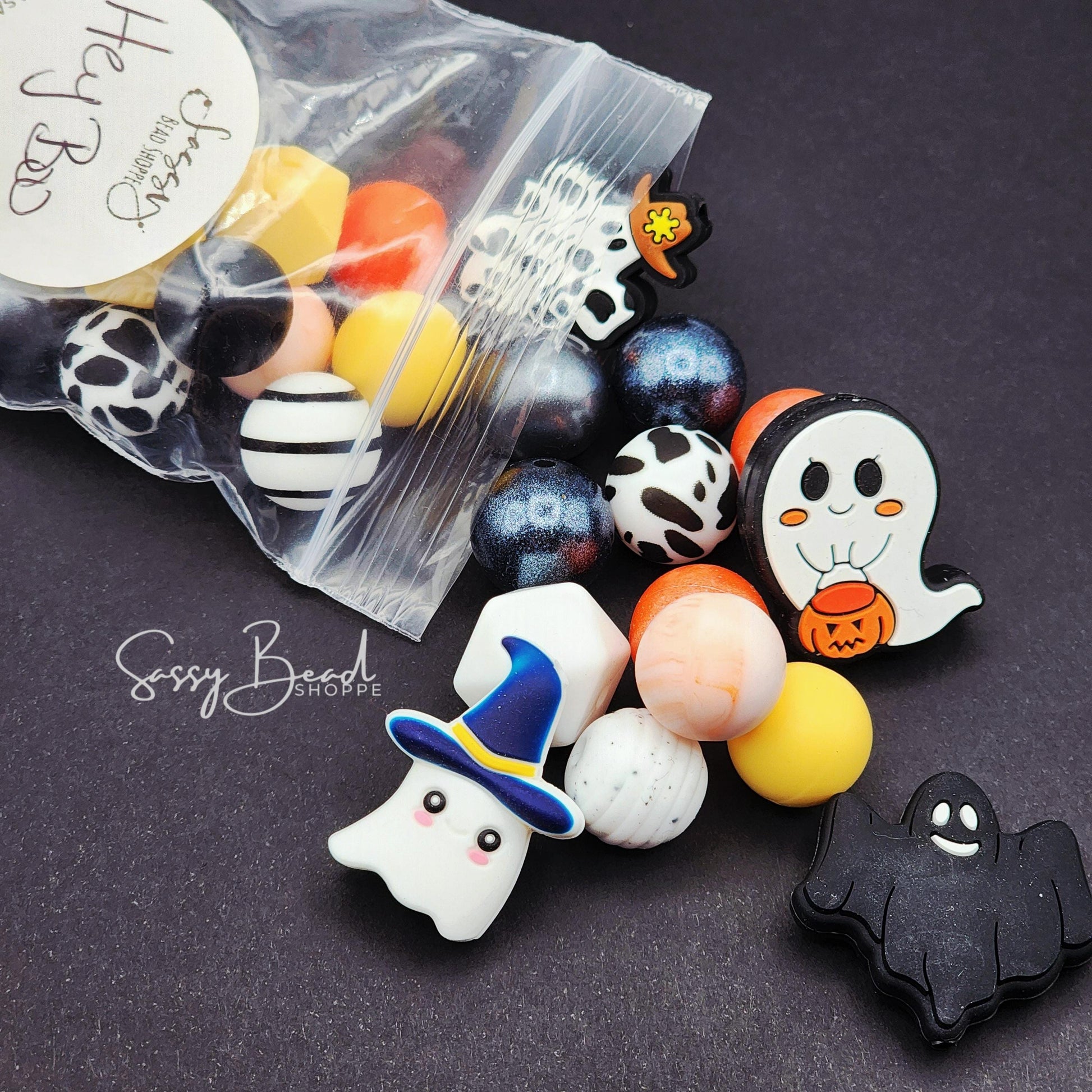 Close-up of Halloween-themed silicone beads with Halloween designs for DIY pens, badge reels, wristlets, cookie scribes, and all your jewelry making