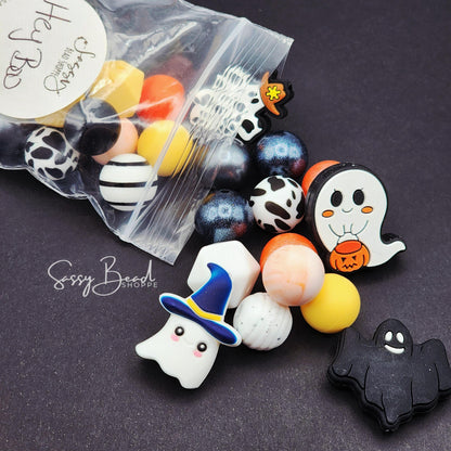 Close-up of Halloween-themed silicone beads with Halloween designs for DIY pens, badge reels, wristlets, cookie scribes, and all your jewelry making