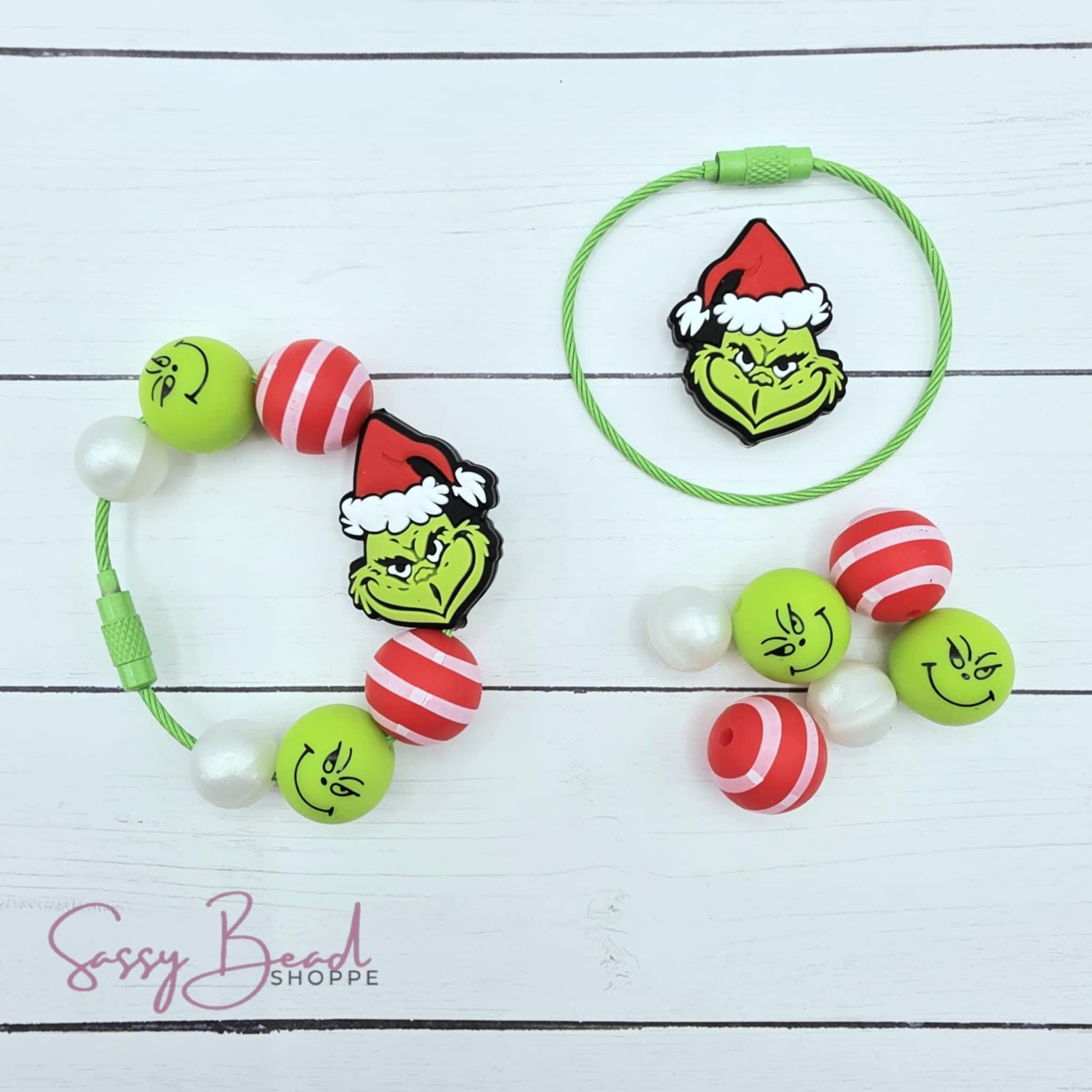 Close-up of Christmas-themed cup charm with mean guy, green guy and stripe designs for tumbler charm. Completed cup charm for reference only