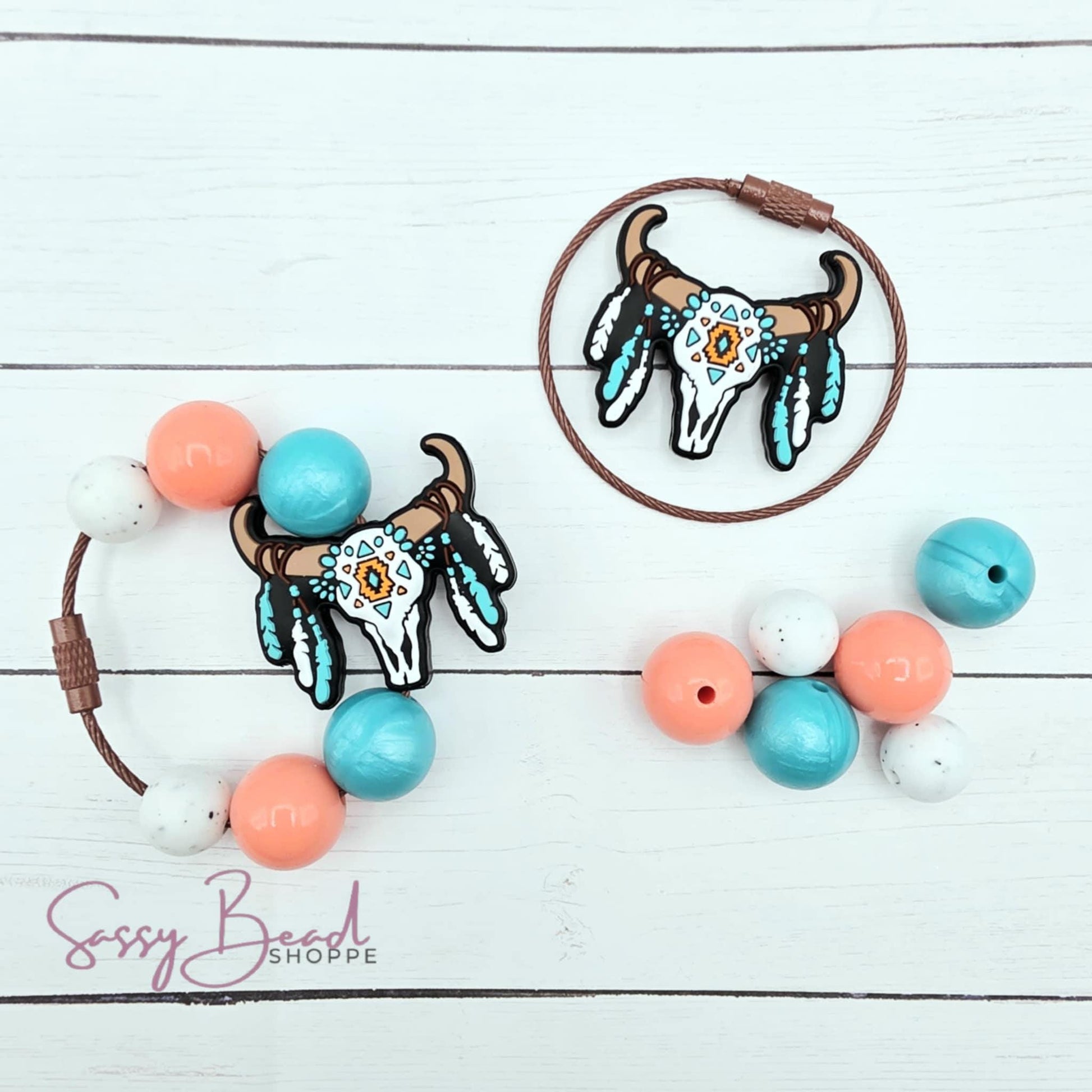 Close-up of Western-themed silicone beads in skull designs for making your tumbler charm. Completed charm is for reference only.