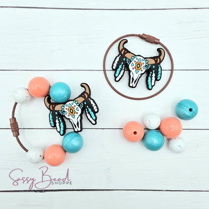 Close-up of Western-themed silicone beads in skull designs for making your tumbler charm. Completed charm is for reference only.