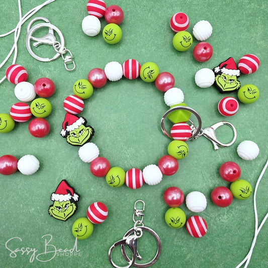 Mean Green Holiday DIY Wristlet with a fun mix of Christmas beads - Green guy focal, red stripe, green guy bead — plus accent beads