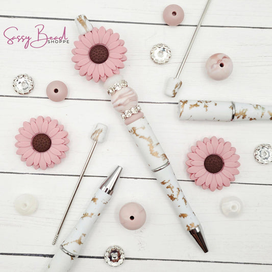 Close-up of flower-themed silicone beads in floral designs for DIY pen making