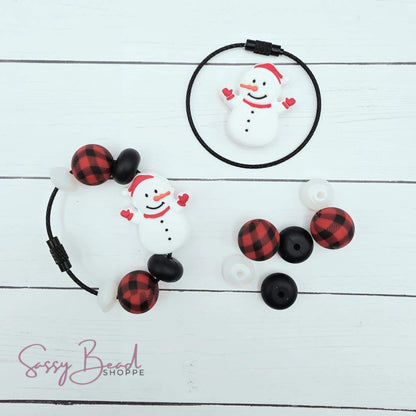 Close-up of Christmas-themed silicone beads in Snowman designs for DIY cup charm making