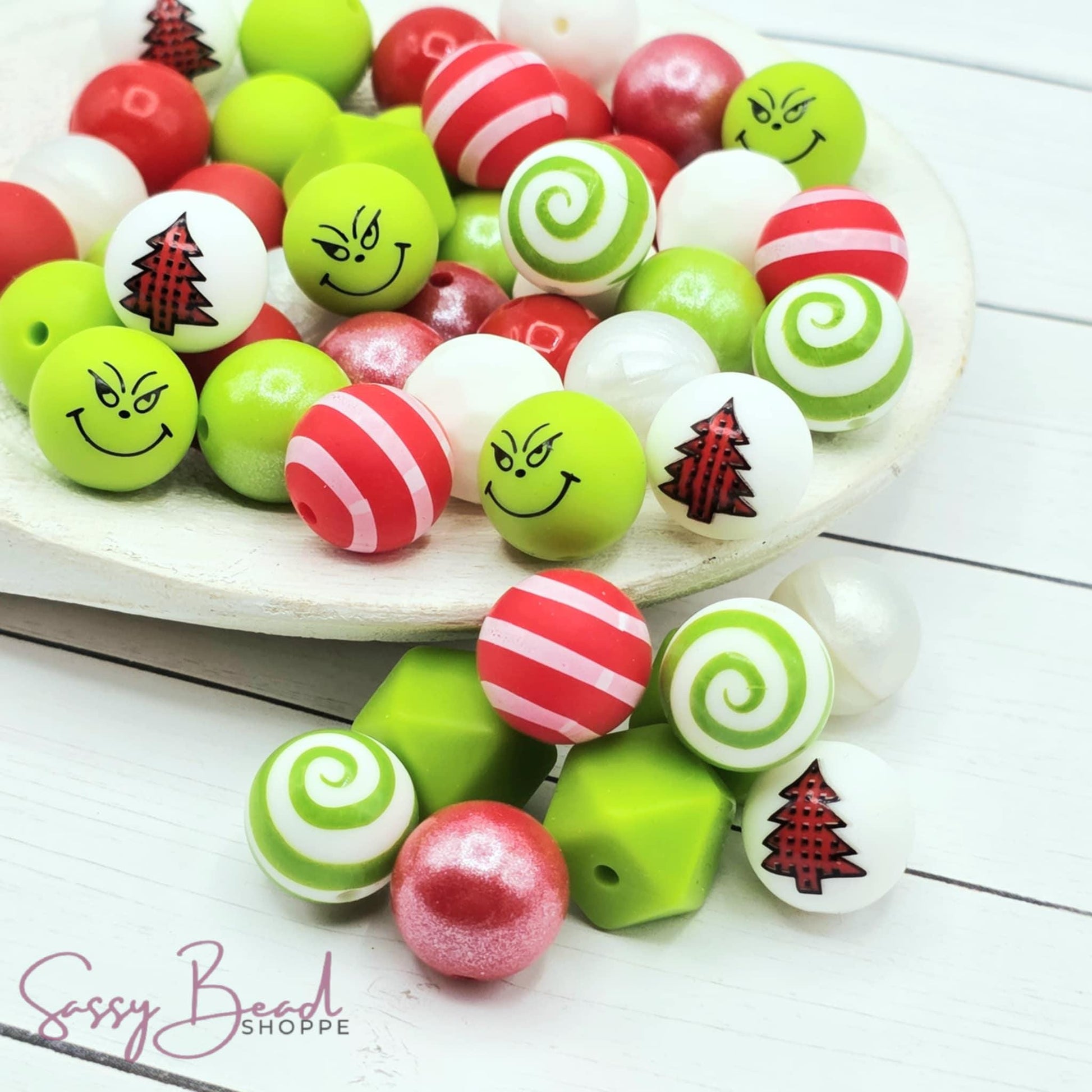 Merry & Mischievous Bead Mix with a fun mix of Christmas beads - green “mean face” bead, red plaid tree, red stripe, and green swirl designs — plus accent beads