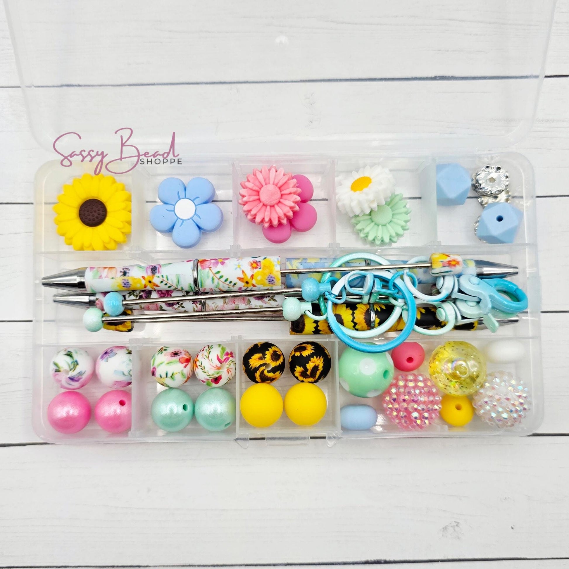 Secret Garden bead kit showing beads for beadable pens and keychains, including seasonal sunflowers, flowers & daisy designs