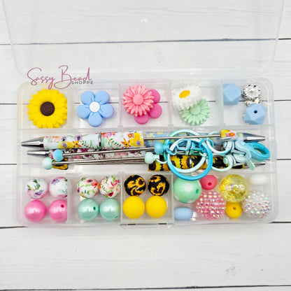 Secret Garden bead kit showing beads for beadable pens and keychains, including seasonal sunflowers, flowers & daisy designs