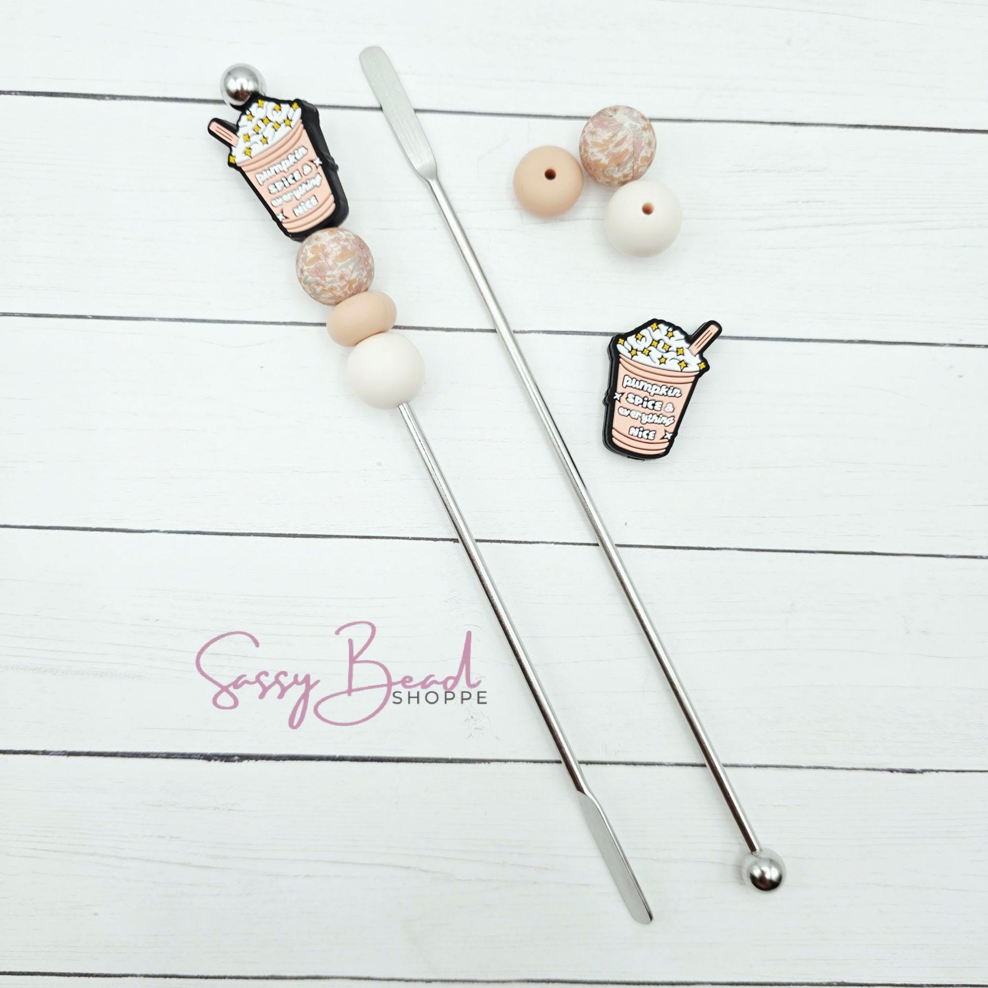 Close-up of Ice Coffee-themed silicone beads in Pumpkin Spice designs for DIY stir stick making