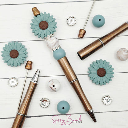 Close-up of flower-themed silicone beads in floral designs for DIY pen making