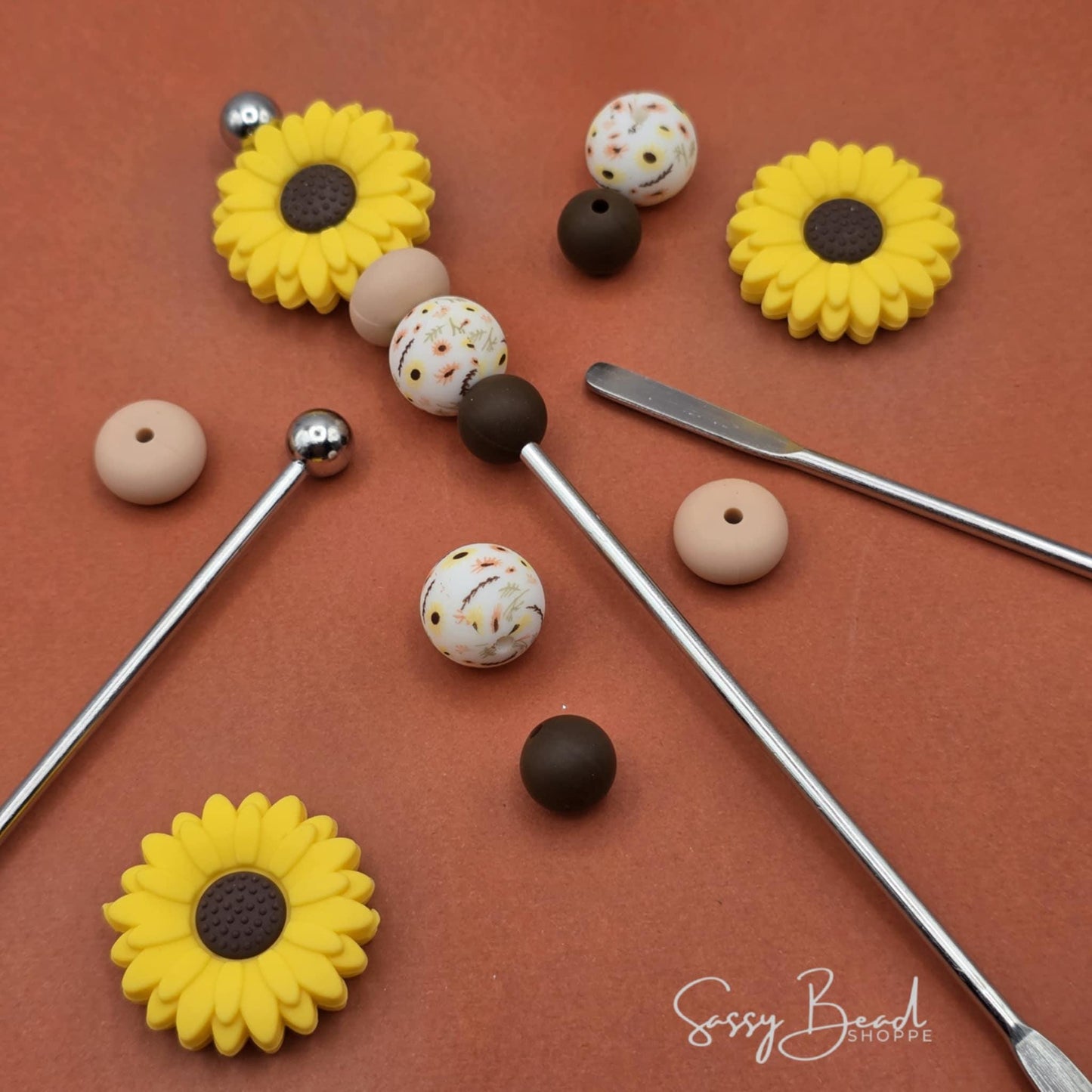 Close-up of Sunflower-themed silicone beads in Flower designs for DIY stir stick making